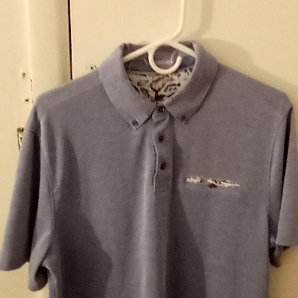 NICOBY POLO shirt size large baby Blue with design inside of it